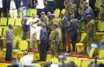 Riot police stop the destruction caused by opposition supporters of Raila Odinga in the presidential race at the Centre in Bomas, Nairobi, Kenya, Monday, Aug. 15, 2022. After last-minute chaos that could foreshadow a court challenge, Kenya’s electoral commission chairman on Monday declared Deputy President William Ruto the winner of the close presidential election over five-time contender Raila Odinga, a triumph for the man who shook up politics by appealing to struggling Kenyans on economic terms and not on traditional ethnic ones. (AP Photo/Sayyid Abdul Azim)