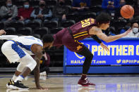 Minnesota's E.J. Stephens (20) tries to get a pass away as Pittsburgh's Jamarius Burton, left, defends during the first half of an NCAA college basketball game Tuesday, Nov. 30, 2021, in Pittsburgh. (AP Photo/Keith Srakocic)