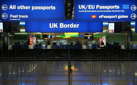 UK Border control is seen in Terminal 2 at Heathrow Airport in London June 4, 2014. Heathrow's rebuilt Terminal 2 welcomed its first passengers on Wednesday, as it began its gradual re-opening. REUTERS/Neil Hall