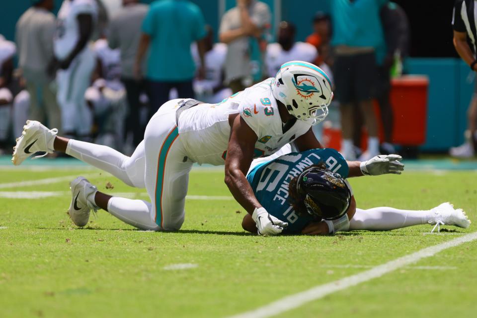 Sep 8, 2024; Miami Gardens, Florida, USA; Miami Dolphins defensive tackle Calais Campbell (93) sacks Jacksonville Jaguars quarterback Trevor Lawrence (16) during the first quarter at Hard Rock Stadium. Mandatory Credit: Sam Navarro-Imagn Images