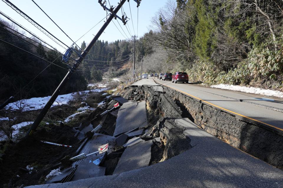 A partially collapsed road affected by landslide caused by a powerful earthquake is seen near Anamizu Town, Ishikawa Prefecture, Tuesday, Jan. 2, 2024. (AP Photo/Hiro Komae)