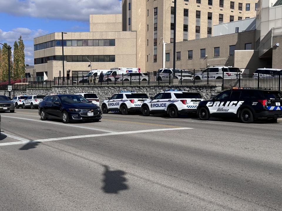 Dozens of officers and state troopers from across several cities in Montgomery and Greene counties gathered outside Miami Valley Hospital Tuesday as Officer Cody Cecil was released from Miami Valley Hospital five days after he was shot while serving a warrant in Clayton. (Scott Kessler/Staff)