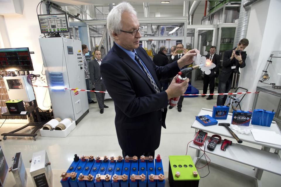 Company HE3DA President Jan Prochazka shows qualities of a new battery during the official start of a battery production line in Prague, on Monday, Dec. 19, 2016. The new battery is based on nanotechnology and is supposed to be be more efficient, long-lasting, cheaper, lighter and above all safer. The battery is designed to store energy from renewable electric sources and cooperate with smart grids. Next planned type will be suitable for electric cars. (Michal Kamaryt /CTK via AP)