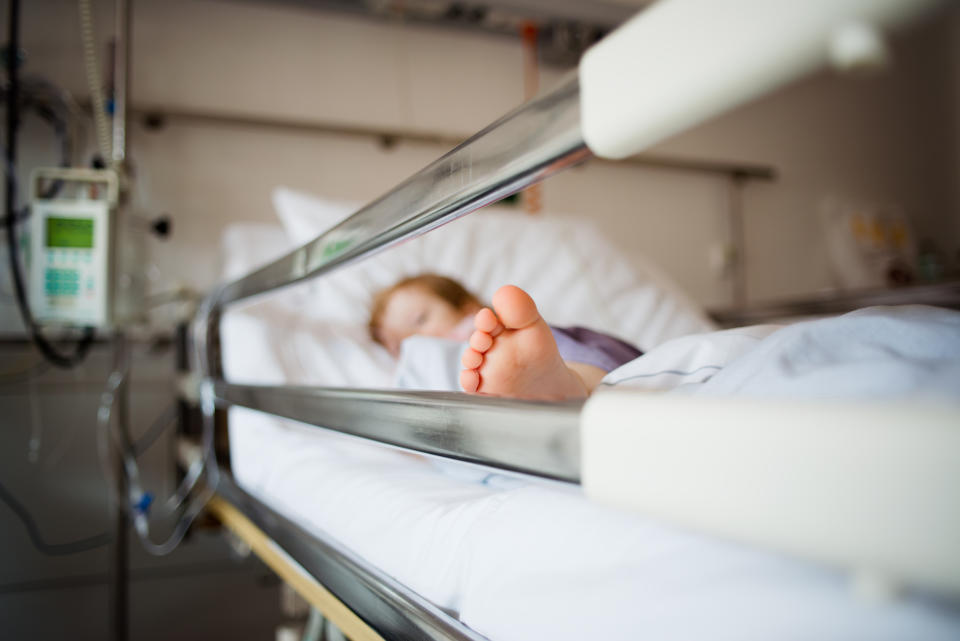 Young girl is lying in a hospital bed