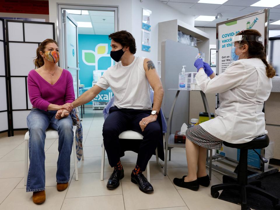 Canada's Prime Minister Justin Trudeau holds hands with his wife Sophie Gregoire before being inoculated with AstraZeneca's vaccine against coronavirus disease (COVID-19) at a pharmacy in Ottawa, Ontario, Canada April 23, 2021.