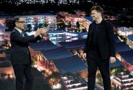 Akio Toyoda, president of Toyota Motor Corporation, applauds Danish architect Bjarke Ingels, CEO of Bjarke Ingels Group, at a news conference during the 2020 CES in Las Vegas