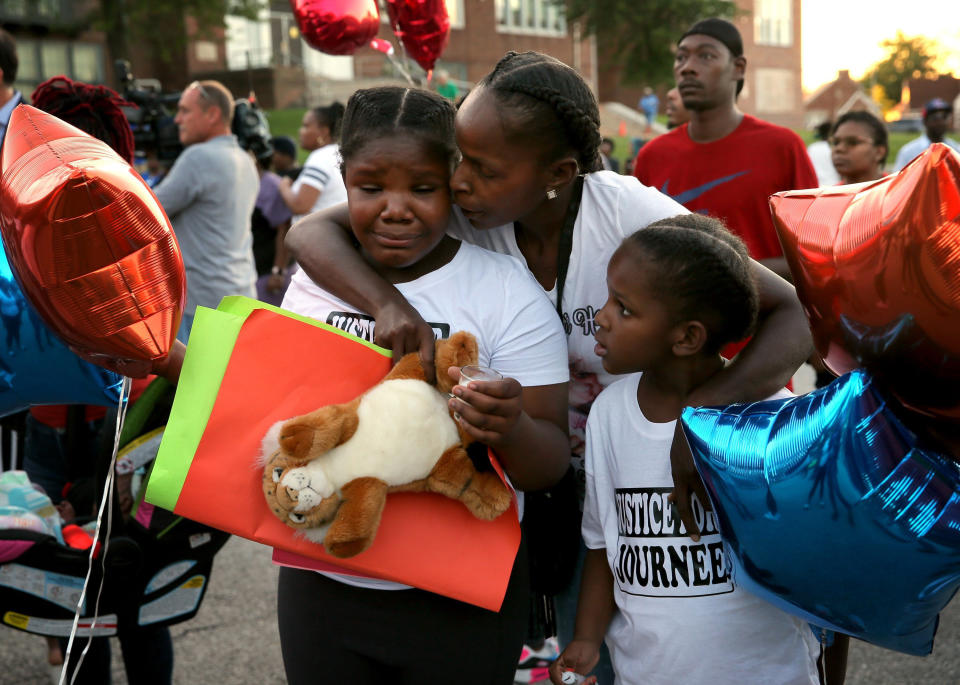 Shardae Edmondson, 11, is consoled by her mother Sharonda Edmondson and sister Zha'lea Thompson, 7, during a vigil for murdered children in St. Louis held at Herzog Elementary School in St. Louis, on Wednesday, Aug. 28, 2019. Shardae and Zha'lea are sisters of 8-year-old Jurnee Thompson who was killed by a stray bullet last Friday night. (David Carson/St. Louis Post-Dispatch via AP) | David Carson—AP