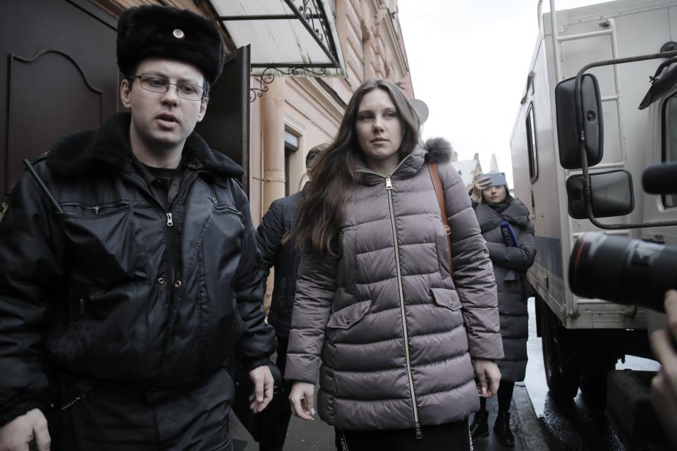 Alla Ilyina, who broke out of the hospital on Feb. 7 after learning that she would have to spend 14 days in isolation instead of the 24 hours doctors promised her, is escorted by a bailiffs form a court after a session in St.Petersburg, Russia, Monday, Feb. 17, 2020.A woman who escaped from a hospital in St. Petersburg, where she was being kept in isolation for possible inflection by the new coronavirus, was ordered by court on Monday to return back to the quarantine for at least two days. (AP Photo/Dmitri Lovetsky)