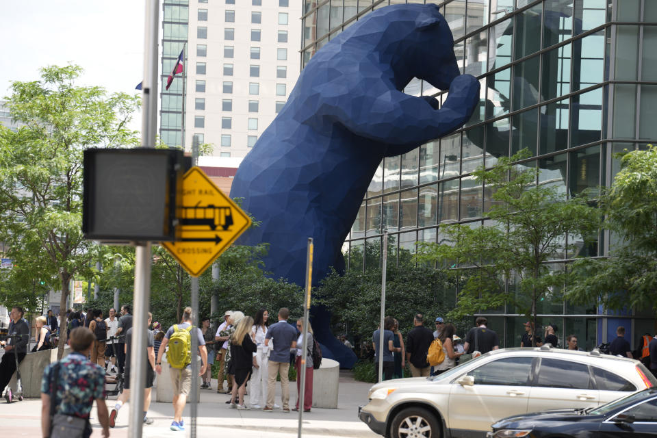 Participants pass by the Blue Bear sculpture on the way into the Psychedelic Science conference in the Colorado Convention Center Wednesday, June 21, 2023, in Denver. (AP Photo/David Zalubowski)