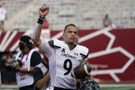 Cincinnati quarterback Desmond Ridder (9) celebrates as he runs off the field following an NCAA college football game, Saturday, Sept. 18, 2021, in Bloomington, Ind. Cincinnati won 38-24. (AP Photo/Darron Cummings)