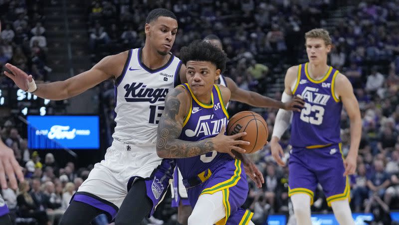 Utah Jazz guard Keyonte George, center, drives as Sacramento Kings forward Keegan Murray (13) defends during the second half of an NBA basketball game Wednesday, Oct. 25, 2023, in Salt Lake City. 
