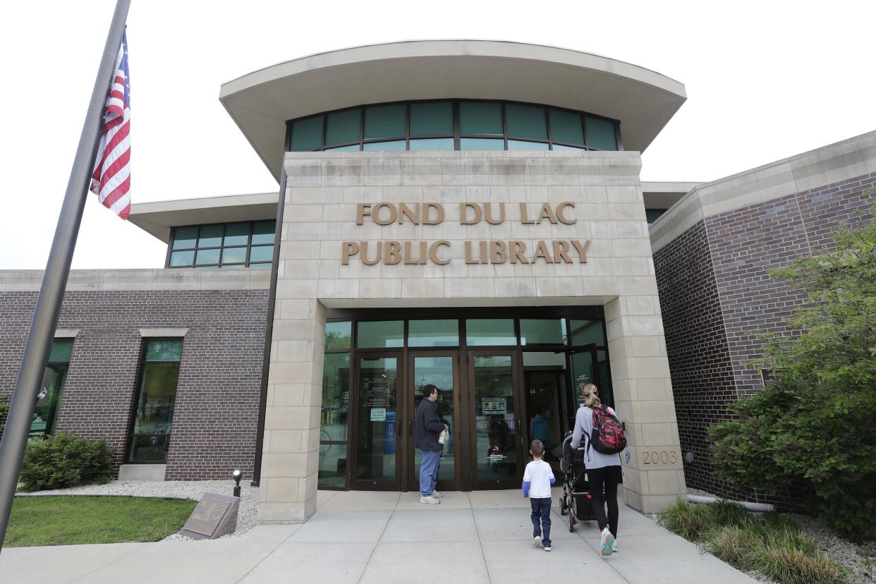 FILE - Community members enter the Fond du Lac Public Library in 2022.