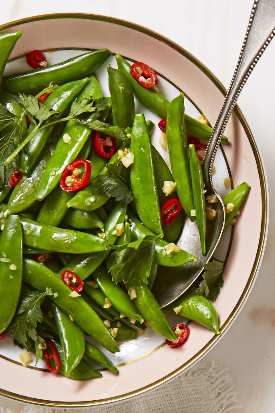 spicy sesame sugar snaps topped with slices of red chiles