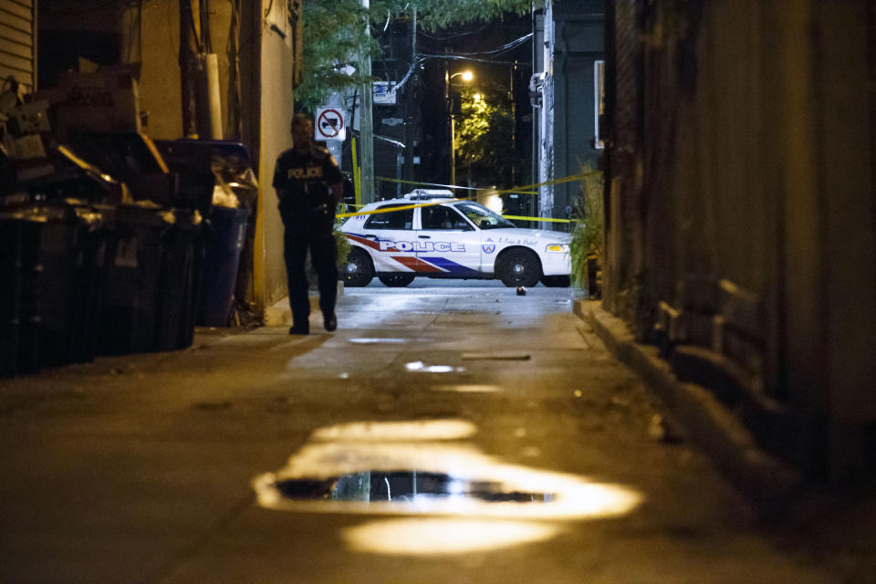 <p>A Toronto Police Officer stands watch at Danforth St. at the scene of a shooting in Toronto, Ontario, Canada on July 23, 2018. (Photo: Cole Burston/AFP) </p>