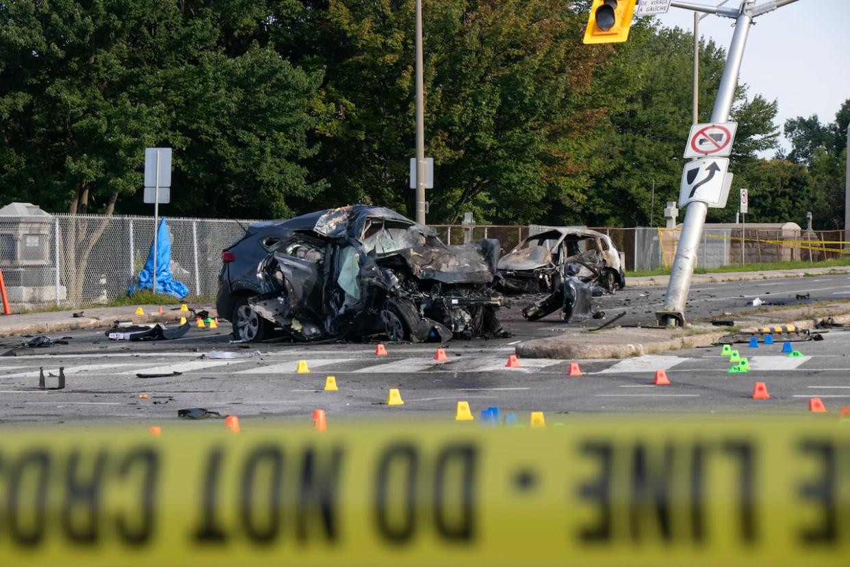 The collision at the corner of Montreal Road and St. Laurent Boulevard killed two men and left vehicles in flames on Aug. 2, 2023. (Arthur White-Crummey/CBC - image credit)