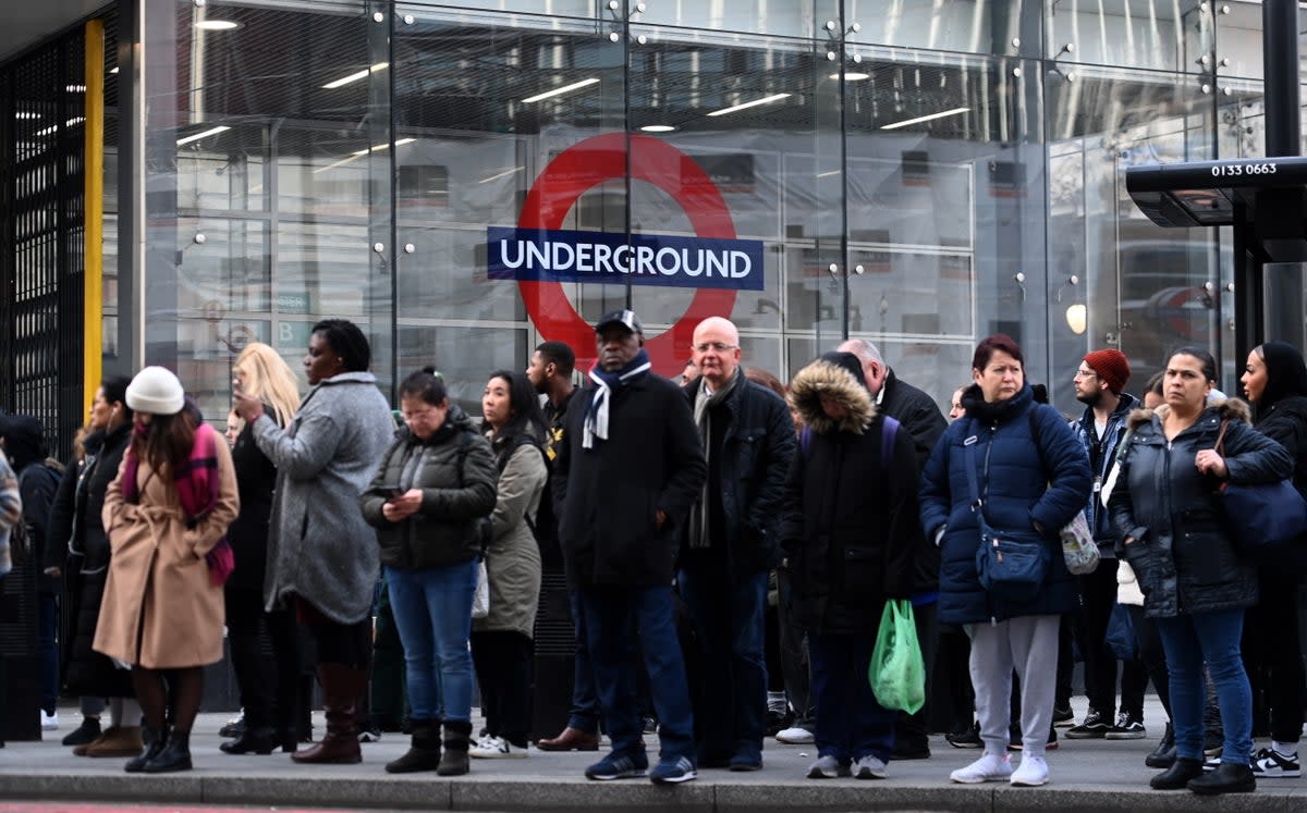 People queue for buses outside Victoria train station in London on Wednesday 15 March  (EPA)