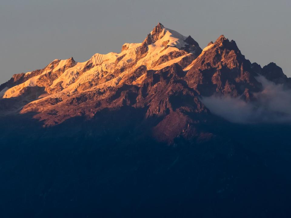 Sunlight illuminating the rugged peaks of the Kangchenjunga Mountain Range, a part of the Great Himalaya Range Sikkim, India: Rex Features