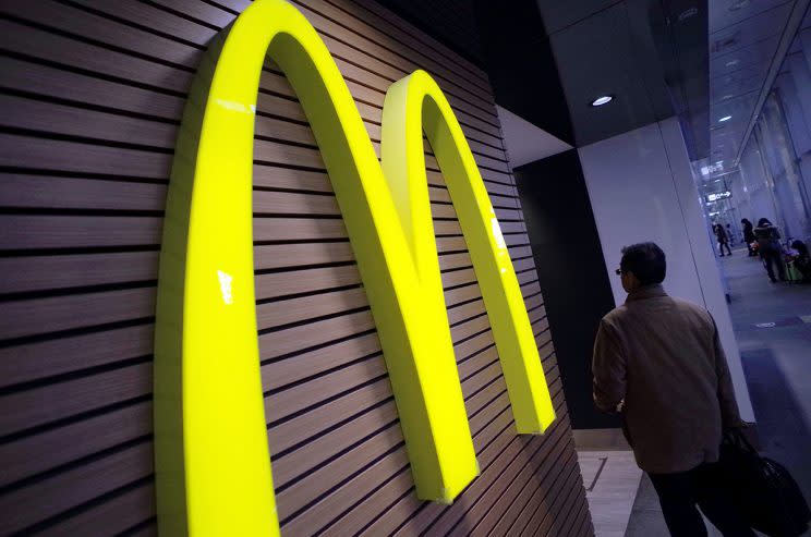 FILE - In this Dec. 17, 2014, file photo, a man walks by a McDonald's restaurant in Tokyo. It was announced Thursday, July 21, 2016, that McDonald’s is the first company to partner with the wildly popular smartphone game “Pokemon Go.