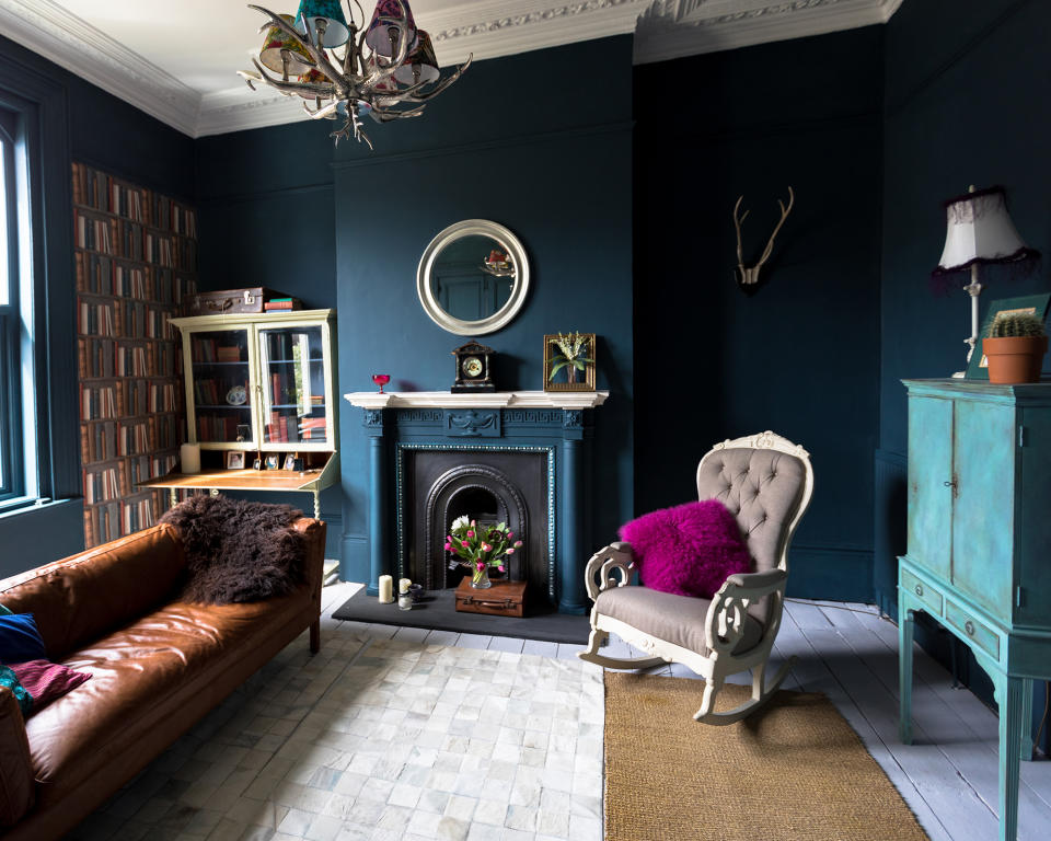 A blue living room with high ceilings and architectural features