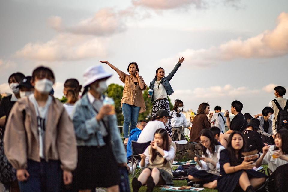 People gather at Rinko Park during the Yokohama port festival, which was held for the first time in three years with no restrictions on the number of attendees and less-strict COVID-19 pandemic restrictions, in Yokohama, Japan, June 2, 2022. / Credit: PHILIP FONG/AFP/Getty