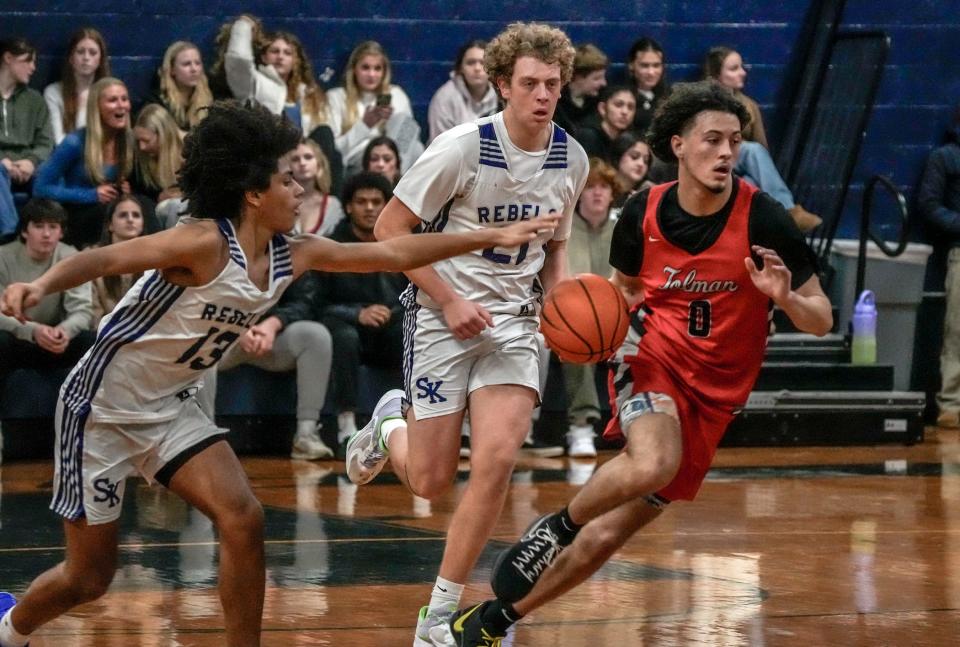 Tolman's Malik Gelinas, right, leads the fastbreak while being pursued by South Kingstown's James Wilson and Noah O’Hagan during Friday night's game.