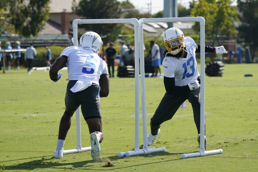 Los Angeles Chargers wide receivers Keenan Allen (13) Joshua Palmer (5) perform a drill at the NFL football team's practice facility Friday, July 29, 2022, in Costa Mesa, Calif. (AP Photo/Marcio Jose Sanchez)