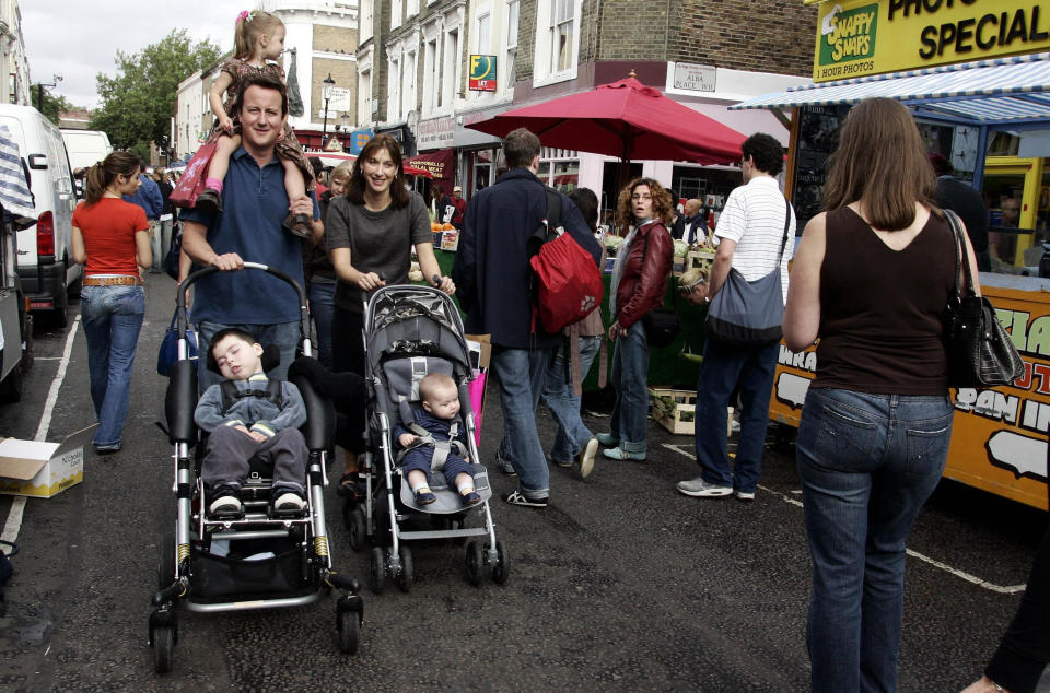 Conservative Party leader David Cameron with his wife Samantha and their daughter Nancy (on shoulders) and sons Ivan (left) and Arthur shopping in Portobello Market in London, on the eve of the Conservative Party Conference in Bournemouth.