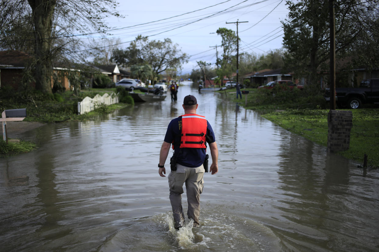 A first responder walks through floodwaters left by Hurricane Ida in LaPlace, La., on Aug. 30, 2021. 