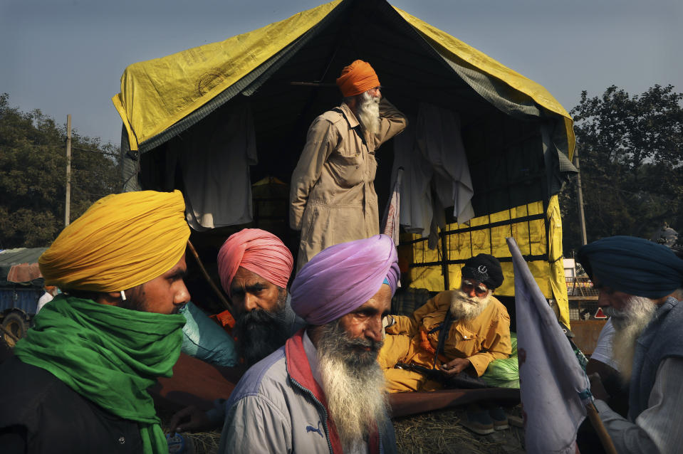 FILE - Indian farmers wait for the outcome of a meeting with the government at the protest site against new agricultural laws, on a highway at the Delhi-Haryana state border, India, Thursday, Dec. 3, 2020. Indian prime minister Narendra Modi's government had insisted that the laws were necessary reforms to modernize Indian farming and would lead to a deregulated market with more private-sector control of agriculture. The farmers said the laws would drastically shrink their incomes and leave them at the mercy of big corporations. After a year, Modi made a surprise announcement to withdraw them. (AP Photo/Manish Swarup, File)