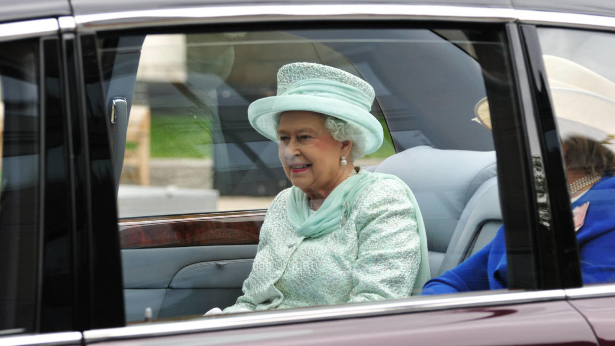 Queen Elizabeth II drives in motorcade with The Lady Farnham