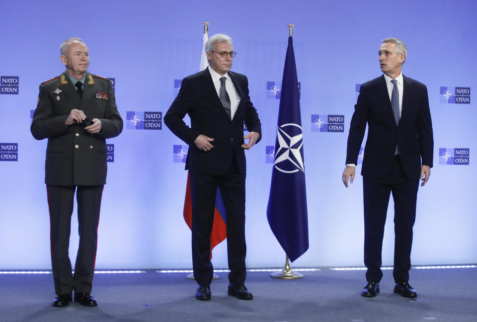 NATO Secretary General Jens Stoltenberg, right, welcomes Russia's Deputy Foreign Minister Alexander Grushko, center, and Russia's Deputy Defense Minister Alexander Fomin prior to the NATO-Russia Council at NATO headquarters, in Brussels, Wednesday, Jan. 12, 2022. Senior NATO and Russian officials are meeting Wednesday to try to bridge seemingly irreconcilable differences over the future of Ukraine, amid deep skepticism that Russian President Vladimir Putin's security proposals for easing tensions are genuine. (Olivier Hoslet, Pool Photo via AP)