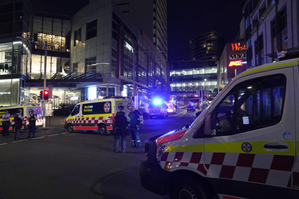 Police officers stand guard outside Westfield Shopping Centre where multiple people were stabbed in Sydney, Saturday, April 13, 2024. A man stabbed six people to death at the busy Sydney shopping center Saturday before he was fatally shot, police said. (AP Photo/Rick Rycroft)