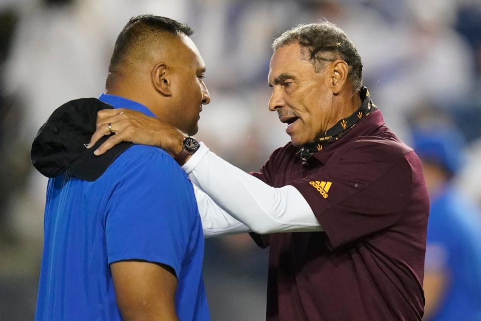 BYU coach Kalani Sitake, left, and Arizona State coach Herm Edwards speak before an NCAA college football game Saturday, Sept. 18, 2021, in Provo, Utah. Some people think that Sitake would be a great choice to replace Edwards as the ASU football coach.