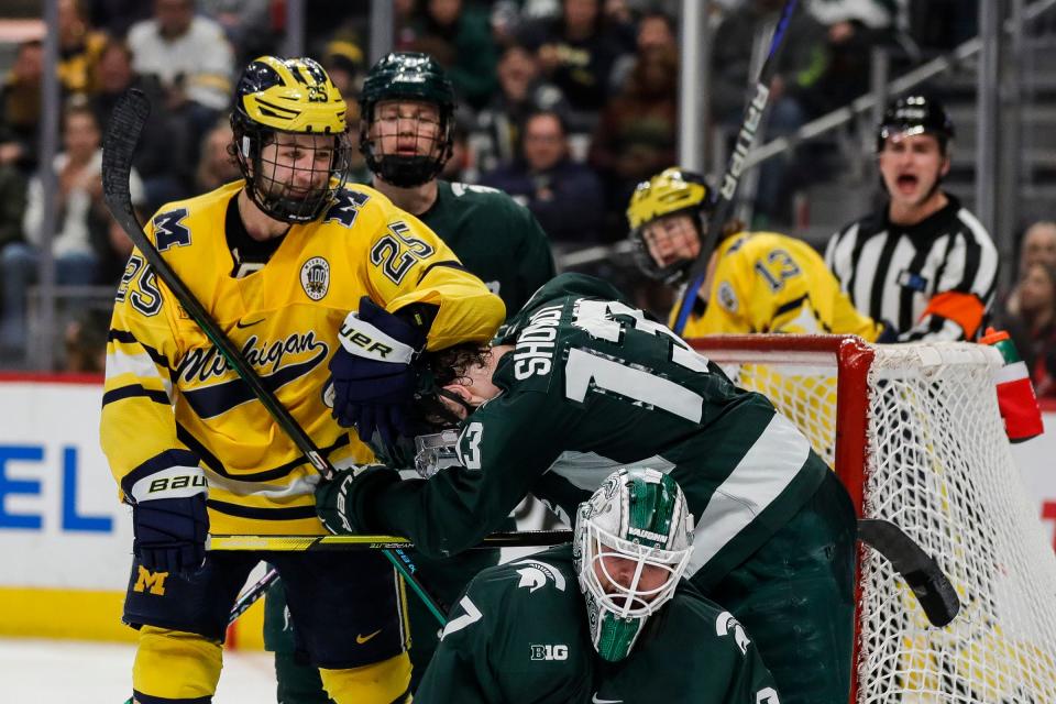 Michigan forward Dylan Duke (25) talks to Michigan State forward Tiernan Shoudy (13) during the third period of the "Duel in the D" at Little Caesars Arena in Detroit on Saturday, Feb. 11, 2023.