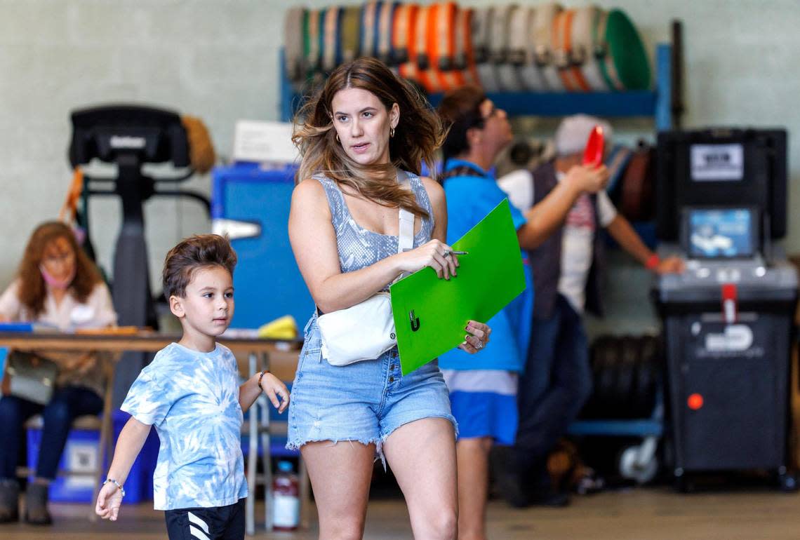 Voters (the adults, anyway) cast ballots during the midterm elections at the Miami Beach Fire Department - Station 4 precinct on Tuesday, Nov. 8, 2022, in Miami Beach, Florida.