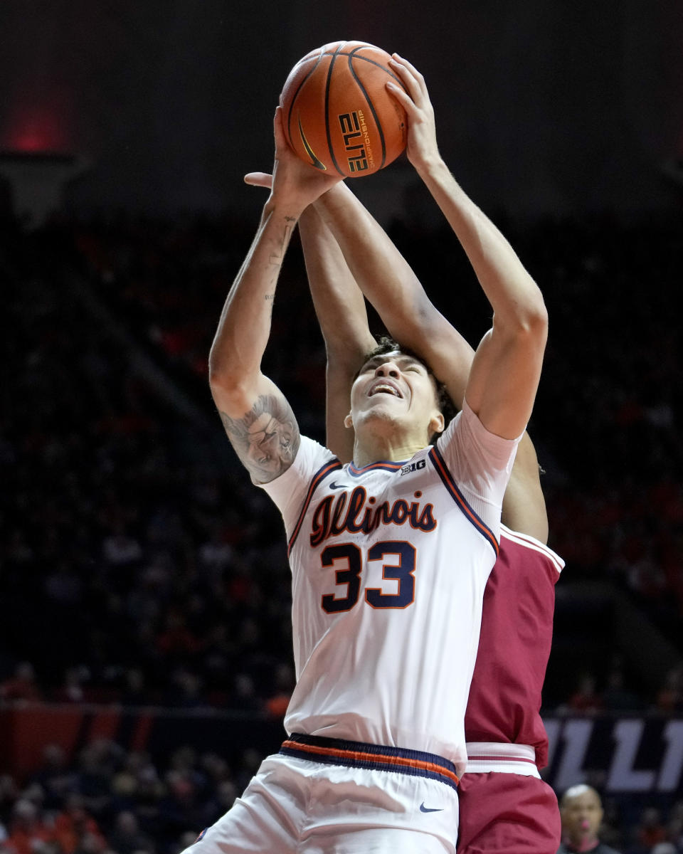 Illinois' Coleman Hawkins (33) drives to the basket as Indiana's Malik Reneau, behind, defends during the first half of an NCAA college basketball game, Saturday, Jan. 27, 2024, in Champaign, Ill. (AP Photo/Charles Rex Arbogast)