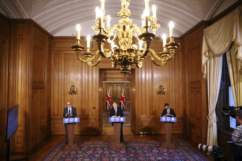 From left, Britain's Chief scientific adviser Sir Patrick Vallance, Prime Minister Boris Johnson and Chancellor of the Exchequer Rishi Sunak take part in a coronavirus briefing, in Downing Street, London, Thursday, Oct. 22, 2020. (Henry Nicholls/Pool Photo via AP)