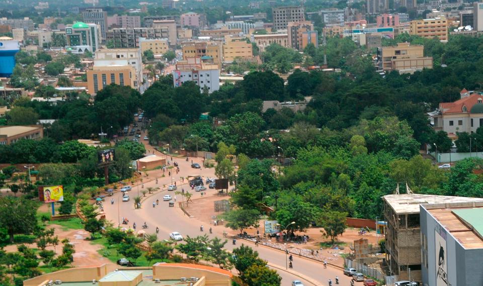 A photo of Ouagadougou, Burkina Faso, showing the street, the trees and some buildings.