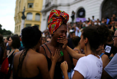 Mourners react outside the city council chamber ahead of the wake of Rio de Janeiro's city councillor Marielle Franco, 38, who was shot dead, in Rio de Janeiro, Brazil, March 15, 2018. REUTERS/Pilar Olivares