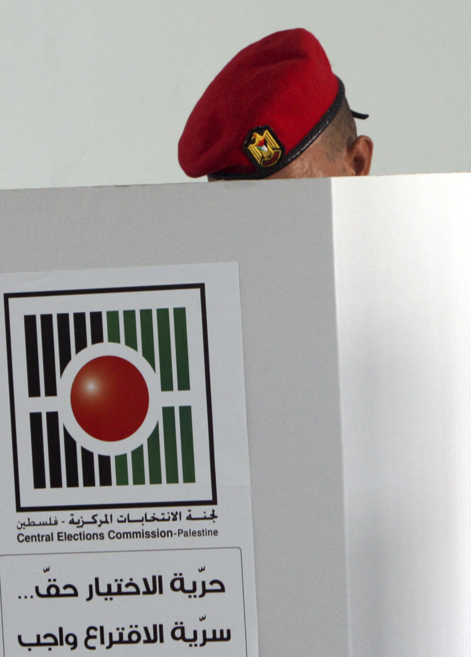 A Palestinian police officer casts an early vote during local elections at a polling station in the West Bank town of Jenin, Thursday, Oct. 18, 2012. Members of Palestinian security forces cast an early vote ahead of local elections which are to take place across the West Bank on October 20, 2012, in the first such polls since 2006. (AP Photo/Mohammed Ballas)