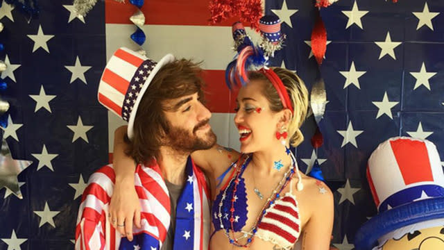 Plenty of celebs got in the holiday spirit this Fourth of July weekend, but no one was as enthusiastic as Miley Cyrus! Then again, this is the girl whose pop hit "Party in the U.S.A." is basically America's national, well, party anthem. <strong>PHOTOS: Celebs Celebrate Independence Day</strong> The social media-loving singer blew up Instagram, posting a ton of patriotic pics with family and friends. First, she and little sister Noah Cyrus showed off their red, white and blue haul. Then the 22-year-old puckered up to her "biew biew," assistant/BFF Cheyne Thomas. <strong>PHOTOS: Hollywood’s Hottest Bikini Bods </strong> The smooches continued with big sister Brandi Cyrus, though we'd say Miley looks more glittery than the "hot mess" she captioned this pic: Miley and her pals also showed off their varying bathing suit looks. <strong>WATCH: Miley on Self-Esteem and Friendship</strong> Miley posted more than pictures of stars and stripes -- she also showed off her new rescue cats, Kiki and Lilo (as in Stitch? Lindsay Lohan?). The sweet snaps included a couple of kitty kisses, as well as a lengthy post that referenced one of the singer's first adopted pets, Floyd, who died last year. <strong>PHOTOS: 11 Reasons America Has Rocked in 2015</strong> Her first pic of the weekend actually came on Friday, however, when she shared this, um, interesting "merry" (we would've gone with hairy) photo with her friend Lauren Winzer, an Australian tattoo artist whose inked Miley in the past. We bow down, Miley -- this is definitely how you get into the holiday spirit! Then again, there's little Miley doesn't go all in on -- see the video of her singing to her deceased blowfish, below, to see what we mean.