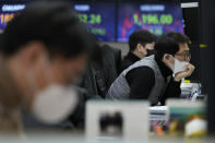 A currency trader watches monitors at the foreign exchange dealing room of the KEB Hana Bank headquarters in Seoul, South Korea, Tuesday, Jan. 25, 2022. Asian shares skidded Tuesday following a volatile day on Wall Street. Inflation-fighting measures from the Federal Reserve and the possibility of conflict between Russia and Ukraine are overhanging markets. (AP Photo/Ahn Young-joon)