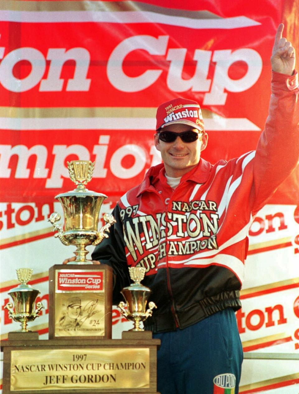 FILE - In this Nov. 16, 1997, file photo, Jeff Gordon, from Pittsboro, Ind., celebrates his second NASCAR Winston Cup Championship at the Atlanta Motor Speedway in Hampton, Ga. Gordon headlines the 10th class of the NASCAR Hall of Fame for his storied career on and off the track. He'll be inducted on Friday night, Feb. 1,2019, along with NASCAR team owners Roger Penske and Jack Roush. (AP Photo/Greg Suvino, File)