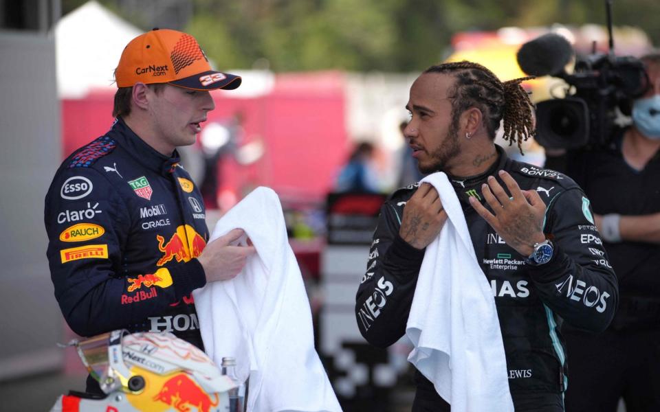 Mercedes' British driver Lewis Hamilton talks to Red Bull's Dutch driver Max Verstappen  - AFP