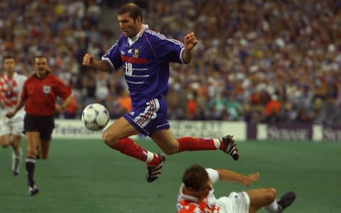 French playmaker Zinedine Zidane jumps over an unidentified Croatian player during the World 98 soccer Cup semifinal match between France and Croatia at the Stade de France in St Denis Wednesday July 8, 1998 - Credit: AP