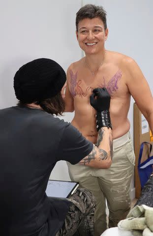 <p>Lydia DeJesus</p> Tattoo artist Akos Strenner works on Janet Wiseman