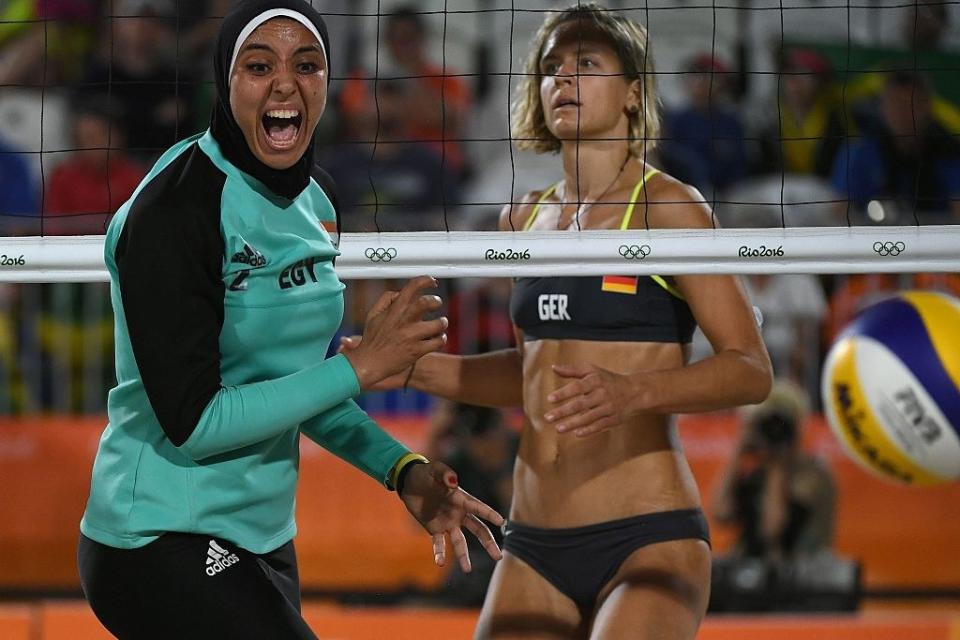 Germany's Laura Ludwig (R) watches as Egypt's Doaa Elghobashy reacts during the women's beach volleyball qualifying match between Germany and Egypt at the Beach Volley Arena in Rio de Janeiro on August 7, 2016, for the Rio 2016 Olympic Games