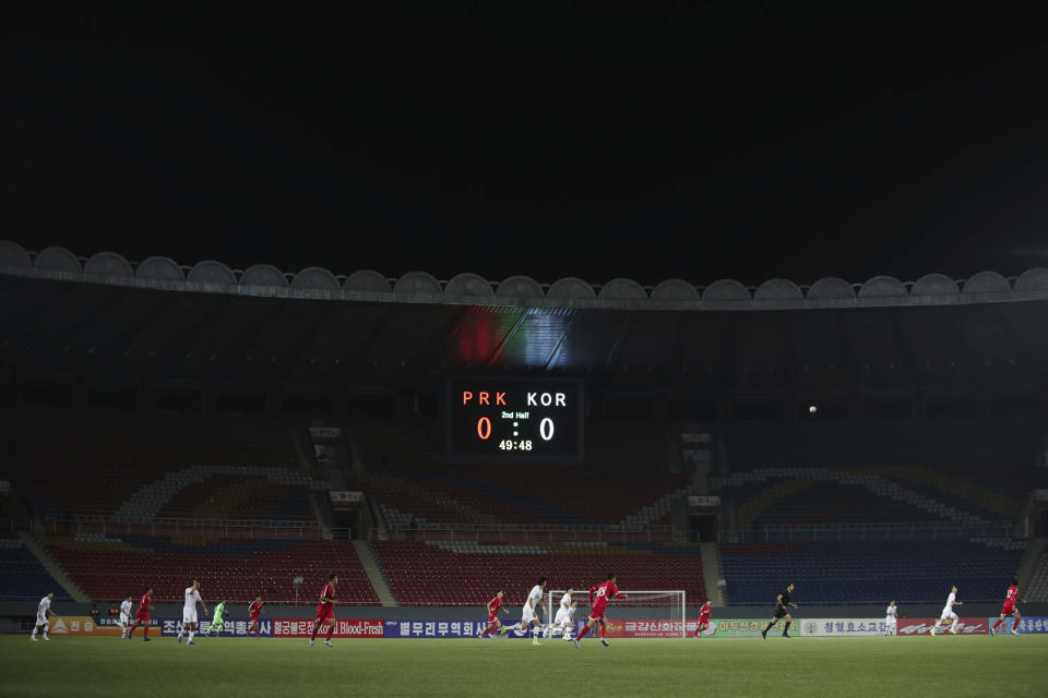 In this photo provided by the Korea Football Association, South and North Korean, wearing red uniforms, players play during their Asian zone Group H qualifying soccer match for the 2022 World Cup at Kim Il Sung Stadium in Pyongyang, North Korea, Tuesday, Oct. 15, 2019. (The Korea Football Association via AP)