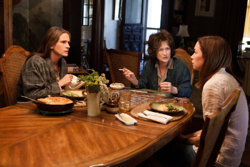 Julia Roberts, Meryl Streep, and Julianne Nicholson talking during dinner.