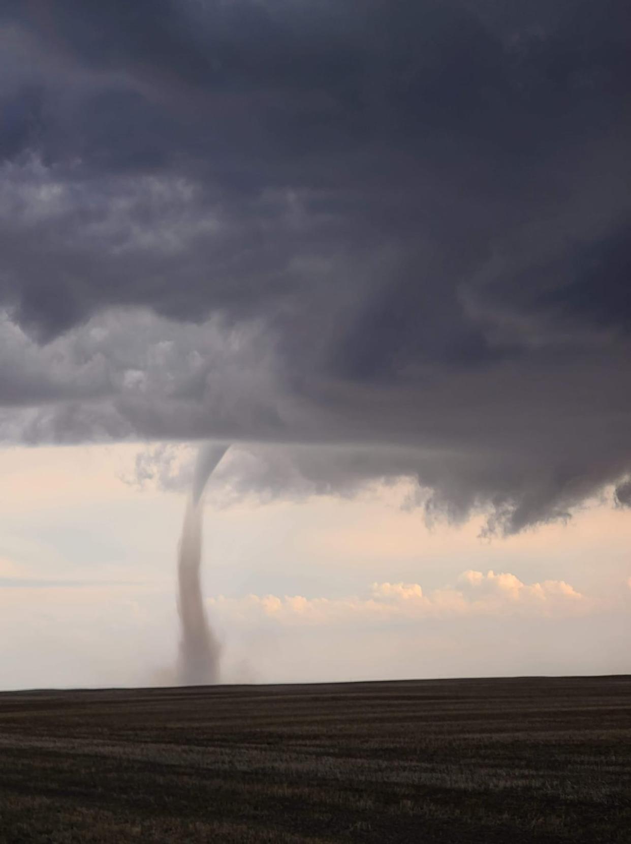 An apparent landspout tornado is shown on the ground in Saskatchewan in 2022.  (Dusty Munsch/Twitter - image credit)